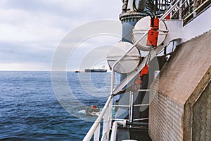 View of ocean from ship or vessel. LSA life saving equipment is on deck photo