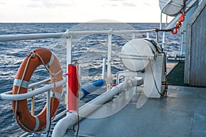 View of ocean from ship or vessel. LSA life saving equipment is on deck photo
