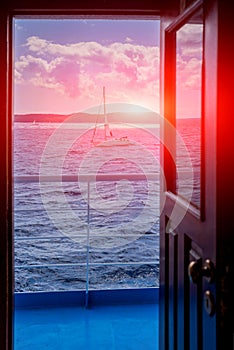 View on the ocean and yachts from open door of captain cabin