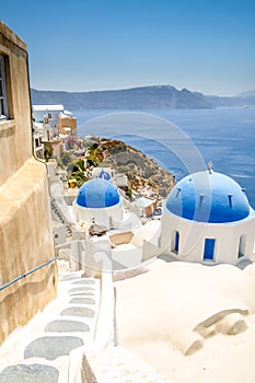 View of oia in santorini and part of caldera, blue church