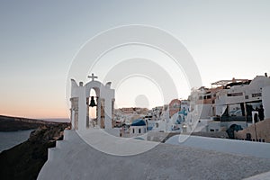 View of Oia town with church on sunset time in Santorini island, Greece.