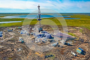 View of the oil rig in the tundra from a helicopter.