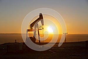 View of Oil Well Pumpjack at Sunset Oil Industry