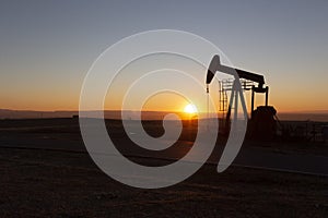 View of Oil Well Pumpjack at Sunset Oil Industry