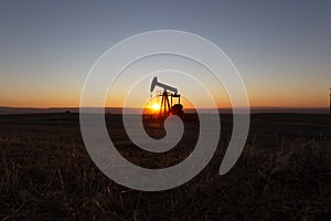 View of Oil Well Pumpjack at Sunset Oil Industry