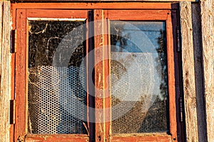 view of an old barn in sunset light, old windows in an ancient building, summer