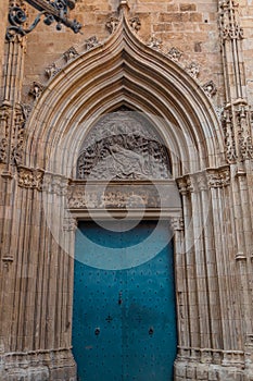 View of the old and beautiful art iron blue color door with door knocker, classic architectural detail in Barcelona