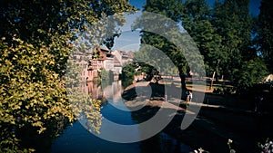 View of the old buildings on the riverbanks reflecting on on the River Ill, Strasbourg