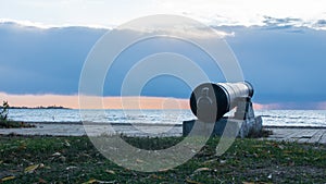 View of an old cannon on the shore as a landmark during synset