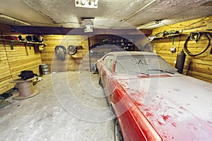 View of old car in garage with dusty hood dirty wind screen with title SALE by finger and broken windshield wiper