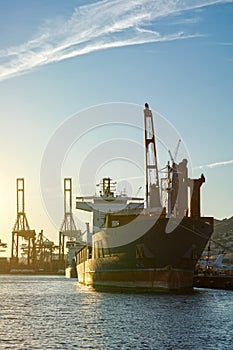 View of an old cargo vessel in a Commercial port.