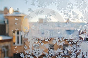 View of the old city house fView of the old city house from a frozen winter window. Texture icerom a frozen winter window.