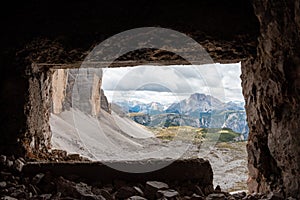 View through an old embrasure in an alpine fortress of the World War I, marking the former Austro-Italian frontier in the Dolomite