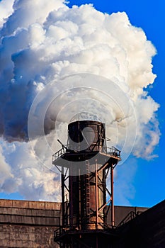 View of old factory with pipe with smoke. Air pollution, environmental damage