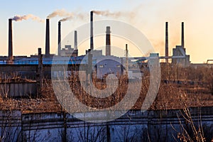 View of old factory with pipes with smoke. Air pollution, environmental damage