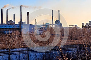 View of old factory with pipes with smoke. Air pollution, environmental damage