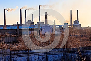 View of old factory with pipes with smoke. Air pollution, environmental damage