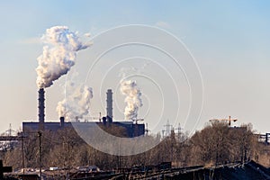 View of old factory with pipes with smoke. Air pollution, environmental damage