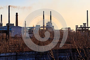 View of old factory with pipes with smoke. Air pollution, environmental damage