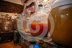 View of old fashioned wine cellar with glass storage for wine during fermentation process