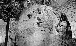 View of old gravestones, seen in monochrome, in an equally old cemetery.