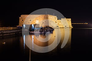 View of old harbour of Heraklion with Venetian Koules Fortress at the night. Crete, Greece. Heraklion by night. Koule fort at Irak photo