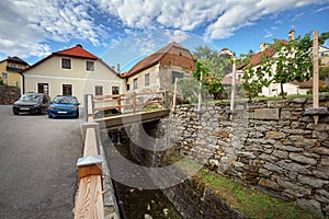 View of the old houses and a bridge over a ditch. Weissenkirchen in der Wachau, Lower Austria.