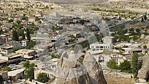 View of old houses and road in Cappadocia. Top view. Cars and motorcycles riding along the road. Travel in Turkey