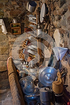 View of old kitchenware in the stone interior of a Catalan farmhouse