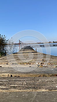 View of the old lake pier on a sunny blue sky day photo