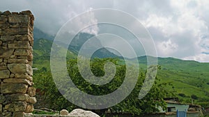 View of old mansory, mountains and mountaon peak with clouds over it