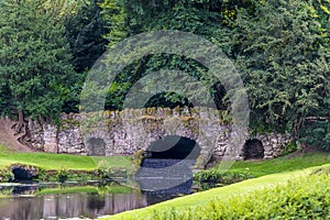 A view an old medieval bridge and weir on the outskirts of Ripon, Yorkshire, UK