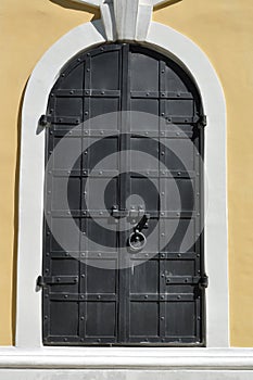 View of the old metal door, the entrance to the old church.