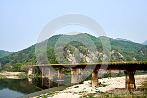 View of an old railroad bridge and its reflection upon the Seom river at Wonju, South Korea