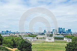 View of Old Royal Naval College, a World Heritage Site in Greenwich, London and skyscrapers of Canary Wharf in the distance.