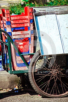 A view of an old rusty metal cart with plastic chairs