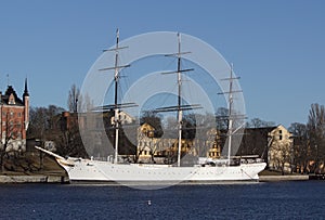 View of old ship and buildings against clear sky