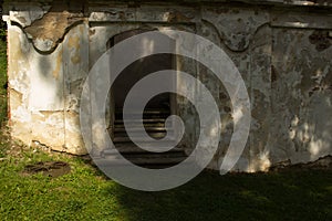 A view of the old staircase and the flaked wall