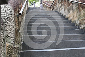 View of an old stairway with metal railings and brick walls in a park