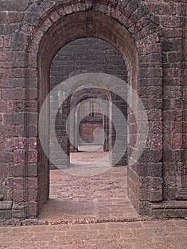 View of the old stone arches of the chapel going into the distance.