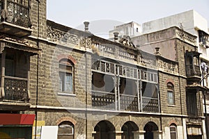 A view of old stone building with windows and balcony at Guruvar Peth, Pune photo