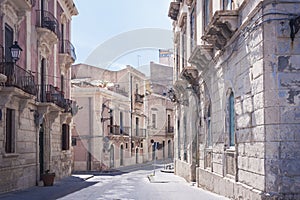 View of old street, facades of ancient buildings in Ortygia Ortigia Island, Syracuse, Sicily, Italy, traditional architecture