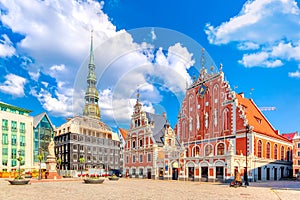 View of the Old Town Ratslaukums square, Roland Statue, The Blackheads House and St Peters Cathedral against blue sky in Riga,