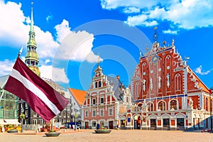 View of the Old Town Ratslaukums square, Roland Statue, The Blackheads House and St Peters Cathedral against blue sky in Riga,