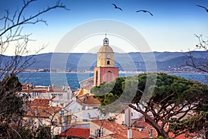 View of the old town with tiled roofs and the Gulf of Saint Tropez, beautiful scenery, a trip to the French Riviera in Provence i