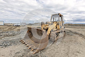 View of the old tracked bulldozer in the construction site.