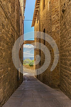 View through the old tuscany street from tuf stone to countryside photo