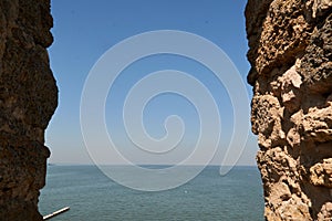 View from the old window - stone frame of landscape. Window in an old stone fortress. Nice weather