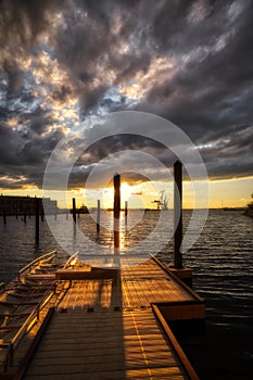 View of the old wooden pier over the sea water at scenic sunset