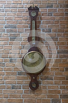 View of an old wooden wall clock, with information on the time and date, weather, temperature